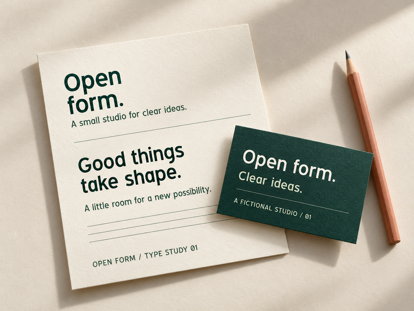 Generated photographic-style concept of cream letterhead and a dark green business card with Open form lettering beside a pencil.