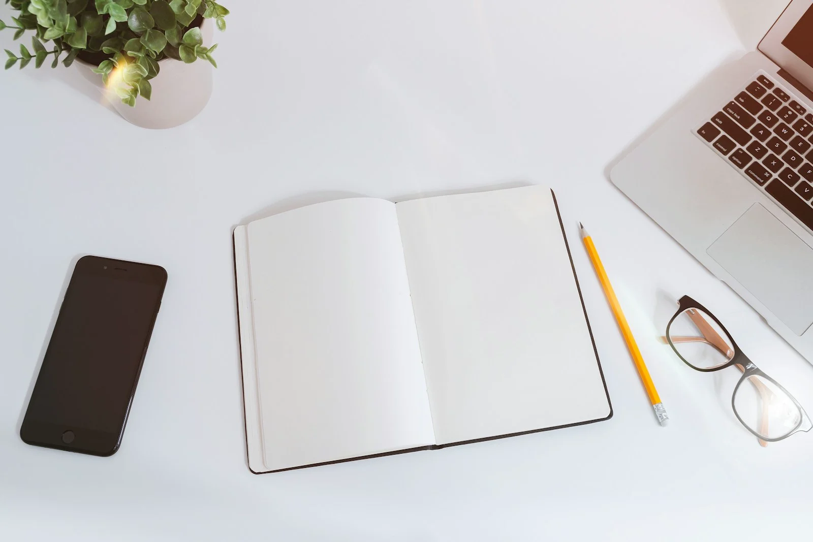 A working care list beside a Designlof project notebook
